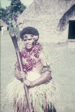 Travel photos. Dancer with traditional percussion weapon and traditional dance jewelry