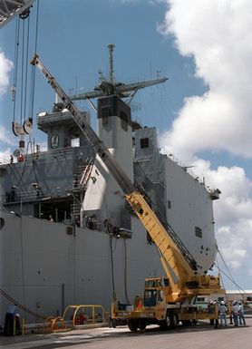 A TMS 870 "Grove" 70-ton truck mounted hydraulic crane is use to offload equipment from the USS FORT MCHENRY (LSD 43) moored to the Sierra Pier on Guam, during Exercise TANDEM THRUST 99