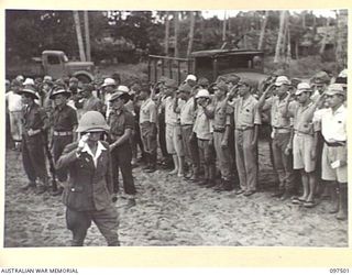 KAHILI, BOUGAINVILLE. 1945-10-01. HIGH RANKING JAPANESE ARMY AND NAVAL OFFICERS ON BOUGAINVILLE WERE ESCORTED IN THEIR OWN BARGES FROM KAHILI FOR CONCENTRATION ON SAMANSO ISLAND. SHOWN, LIEUTENANT ..