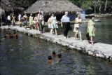 French Polynesia, tourists walking on pier at Bora Bora