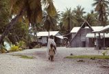 Village scene showing native woman with child, Rongelap Island, August 24, 1964