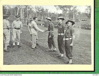 BISIATABU, NEW GUINEA. 1944-04-19. THE HONOURABLE E.J. WARD, MINISTER FOR EXTERNAL TERRITORIES IN THE AUSTRALIAN GOVERNMENT, BEING INTRODUCED TO EUROPEAN NON COMMISSIONED OFFICERS AT A SPECIAL ..