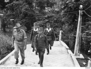 RABAUL, NEW BRITAIN. 1945-11-05. GENERAL H. IMAMURA, FORMER COMMANDER JAPANESE EIGHTH AREA ARMY, ARRIVING AT HEADQUARTERS 11 DIVISION, TO CONFER WITH MAJOR GENERAL K.W. EATHER, GENERAL OFFICER ..