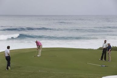 Barack Obama plays golf with Prime Minister Najib Razak, Joe Paulsen, and Mike Brush in Kaneohe Bay, Hawaii, December 24, 2014