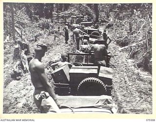 BOUGAINVILLE ISLAND. 1945-02-27. A JEEP TRAIN OF THE 7TH INFANTRY BRIGADE, LOADED WITH SUPPLIES FOR THE FORWARD TROOPS, MAKING ITS WAY THROUGH THE MUD AND SLUSH OF THE MOSIGETTA ROAD