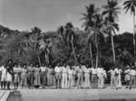 Photograph of a line of 22 people on a beach in Fiji