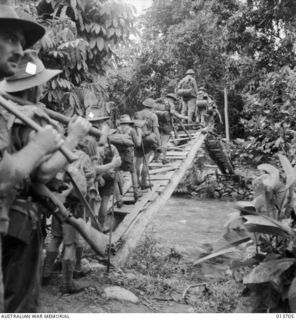 Wairopi Area, New Guinea. 1942-11. Australian troops cross one of the many streams on the way to Wairopi which they captured on 1942-11-11