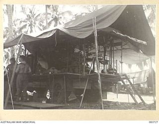 AITAPE, NEW GUINEA. 1944-11-22. A MACHINERY VEHICLE AT 135 BRIGADE WORKSHOP. THE VEHICLE CONTAINS AN 8 INCH LATHE, LARGE AND SMALL ELECTRIC DRILLS, AND ITS SIDES FOLD OUTWARDS TO FORM WORK BENCHES