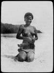 Portrait of young woman sitting on beach