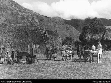 Dr Susan Serjeantson, Department of Human Biology, John Curtin School of Medical Research at the ANU, and Dr Hornabrook of the Institute of Medical Research in Papua New Guinea, examine villagers in Kewieng (at 8,000 feet) in the Finistere Ranges of Papua New Guinea