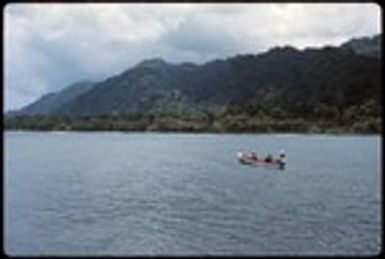 Men on boat heading towards island
