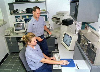 US NavyPhotographer's Mate 3rd Class (PH3)Michael A. Meyers (top) works with Photographer's Mate AIRMAN (PHAN)Marjorie R. McMillen, USN, (bottom) on Electronic Imaging training at Fleet Imaging Center Pacific, Agana Naval Air Station, Guam, 5 May 1998