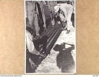 DREGER HARBOUR, NEW GUINEA. 1943-12-03. ENGINEERS OF THE 870TH UNITED STATES AVIATION ENGINEER BATTALION LAYING STEEL SECTIONS FOR A NEW LANDING STRIP WHICH WILL BE 6000 FEET LONG AND 110 FEET WIDE ..