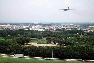 A 43rd Bombardment Wing B-52G Stratofortress aircraft passes over the city as it flies into Yokota Air Base for the annual Japanese-American Friendship Festival. The aircraft is based at Anderson Air Force Base, Guam