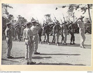LAE AREA, NEW GUINEA, 1945-08-05. BRIGADIER P.S. MCGRATH, DEPUTY DIRECTOR OF SUPPLIES AND TRANSPORT (1), TAKING THE SALUTE FROM 75 PLATOON, 151 GENERAL TRANSPORT COMPANY, DURING THE MARCH PAST