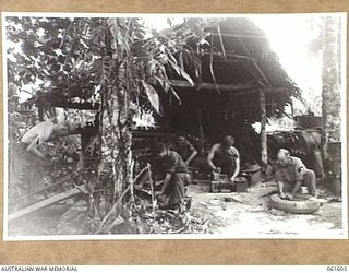 FINSCHHAFEN AREA, NEW GUINEA. 1943-11-24. MOTOR TRANSPORT WORKSHOPS OF THE 2/3RD AUSTRALIAN FIELD COMPANY, ROYAL AUSTRALIAN ENGINEERS. SHOWN ARE: QX4376 SERGEANT T. MILLER OF BRISBANE, QLD, (1); ..
