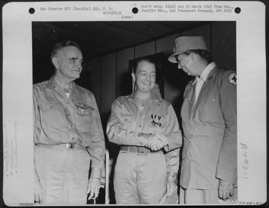Mrs. F. D. Roosevelt Congratulates Lt. Hugh Blair Miller, Jr., Usn, Center, From Tuscaloosa, Ala., After He Was Awarded The Navy Cross And The Purple Heart By Adm. Wm. F. Halsey At Noumea, New Caledonia, 1943. (U.S. Air Force Number 75081AC)