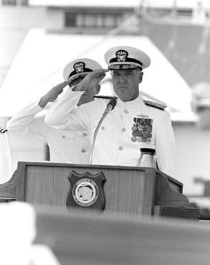 CHIEF of Naval Operations Designate ADM James D. Watkins, right, and ADM Sylvester R. Foley Jr. salute as the national anthem is played. Foley is assuming command of the U.S. Pacific Fleet