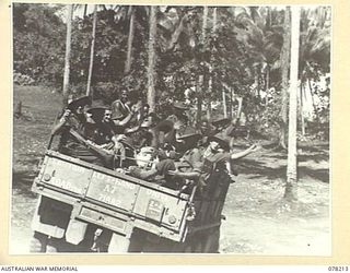 AITAPE, NEW GUINEA. 1945-01-08. PERSONNEL OF "JOCK FORCE" MOVING OFF FOR YAKAMUL ABOARD A 3 TON TRUCK "JOCK FORCE" IS COMMANDED BY NX122980 CAPTAIN A J MARSHALL, THE ONE ARMED OFFICER IN CHARGE, ..