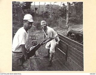 KAIRIRU ISLAND, NEW GUINEA, 1945-09-08. JAPANESE SOLDIERS LOADING SURRENDERED WEAPONS AND EQUIPMENT ONTO TRUCK FOR REMOVAL TO HQ 6 DIVISION. HANDING OVER OF WAR WEAPONS BY THE JAPANESE IS IN ..