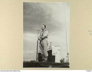 LAE, NEW GUINEA. 1944-11-05. NX70612 CHAPLAIN H.J. REID, DEPUTY ASSISTANT CHAPLAIN GENERAL, (ROMAN CATHOLIC) 2ND AUSTRALIAN CORPS, ASSISTING DURING THE CELEBRATION OF A SOLEMN REQUIEM MASS AT THE ..