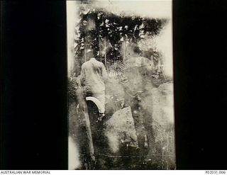 Kabakaul (?), New Britain. c. 1914-09-12. Two mourners beside the grave during the funeral service for Able Seaman W.G.V. Williams RAN, born Melbourne 1885, believed to be the first Australian shot ..