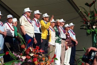 Thirty-one crew members of the USS ARIZONA who survived the Dec. 7, 1941, attack on Pearl Harbor stand to receive the applause of the audience during Remembrance Day ceremonies at the USS ARIZONA Memorial Visitors Center commemorating the 50th anniversary of the bombing