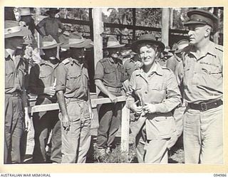TOROKINA, BOUGAINVILLE. 1945-08-16. GRACIE FIELDS, NOTED LANCASHIRE VOCALIST AND COMEDIENNE BEING RESCUED FROM AUTOGRAPH HUNTERS AFTER THE VICTORY THANKSGIVING SERVICE HELD AT GLOUCESTER OVAL