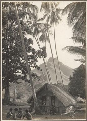 Scenes at Boianai [hut with a group of men sitting and standing outside] Frank Hurley