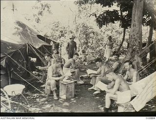 KIRIWINA, TROBRIAND ISLANDS, PAPUA. 1943-11-27. AIRCREW OF NO. 30 (BEAUFIGHTER) SQUADRON RAAF OUTSIDE THEIR TENTS IN A JUNGLE CAMP FOLLOWING THE MOVE FROM GOODENOUGH TO KIRIWINA