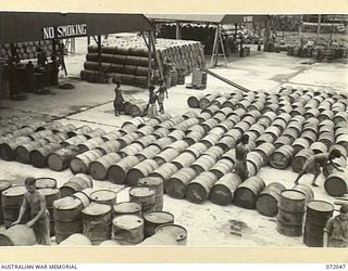 MILNE BAY, NEW GUINEA. 1944-04-04. THE DRUM REFILLING PLANT AT THE 2ND AUSTRALIAN BULK PETROLEUM STORAGE COMPANY TERMINAL