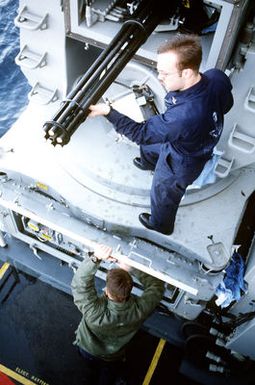 A fire control technician performs preventive maintenance on one of the 20mm Mark 15 Phalanx close-in weapons systems (CIWS) on the amphibious assault ship USS GUAM (LPH-9)