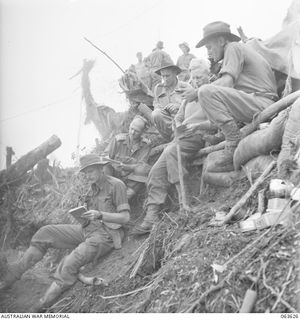 SHAGGY RIDGE, NEW GUINEA. 1944-01-20. OFFICERS OF A COMPANY 2/9TH INFANTRY BATTALION, HAVING A FINAL CONFERENCE WITH THEIR SENIOR NON COMMISSIONED OFFICERS PRIOR TO THE ATTACK ON GREEN SNIPERS ..