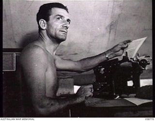 POMPOM VALLEY, NEW GUINEA. 1943-10-26. NX31048 STAFF SERGEANT E. C. DUNN, PRODUCER OF THE 7TH AUSTRALIAN DIVISION CONCERT PARTY, AT THE TYPEWRITER PREPARING THE SCRIPT FOR A NEW SHOW