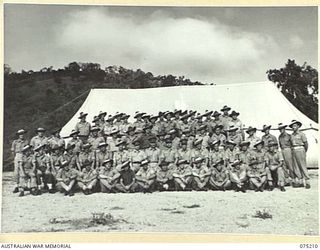 PORT MORESBY, PAPUA. 1944-08-16. PERSONNEL OF THE ORDNANCE VEHICLE PARK SECTION OF THE 10TH ADVANCED ORDNANCE DEPOT. THE COMMANDING OFFICER OF THE UNIT VX89010 CAPTAIN W.M. BREIT, IS SEATED IN THE ..