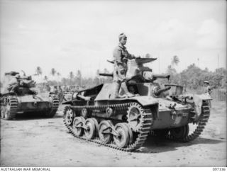 Rapopo Airstrip, New Britain.  A Japanese tank crew bringing a type 95 Ha-Go light tank out of the lines to hand over to Australian crews of 2/4 Armoured Regiment.  A total of over 40 Japanese ..