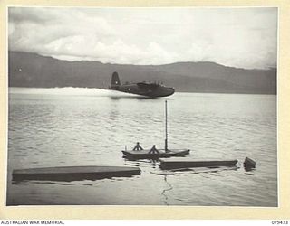 JACQUINOT BAY, NEW BRITAIN. 1945-03-10. THE RAAF SHORT "SUNDERLAND" FLYING BOAT, CARRYING THE FIRST NEW BRITAIN AIR MAIL, MAKING A LANDING ON THE BAY