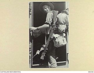 CAIRNS, QLD. 1944-10-30. LANCE-CORPORAL MACKIESON, HEADQUARTERS COMPANY 2/4 INFANTRY BATTALION, ABOARD THE TROOPSHIP USS MEXICO, HEADS BELOW TO LIVING QUARTERS DURING THE MOVEMENT TO NEW GUINEA OF ..