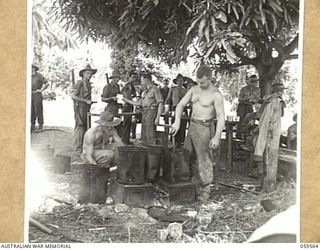 FINSCHHAFEN AREA, NEW GUINEA, 1943-10-23. MAKING COFFEE AT THE YOUNG MEN'S CHRISTIAN ASSOCIATION (YMCA) STALL USING SUGAR DRUMS AND KEROSENE TINS. SHOWN ARE:-NX36566 PRIVATE L. HARRINGTON (3); ..