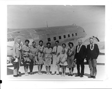 Group of unidentified people, including European and Pacific Islanders [Cook Islanders?] in front of a NZ3519 C47 transport aircraft, Aitutaki airport, Cook Islands