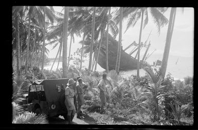 Group of unidentified RNZAF airmen observing the wreck of a Japanese ship, Guadalcanal, Solomon Islands
