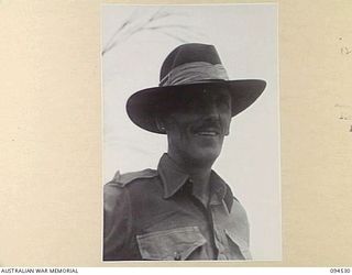 CAPE WOM, WEWAK, NEW GUINEA, 1945-07-29. WARRANT OFFICER 1 C.W. MITCHELL, AT 6 DIVISION RECEPTION CAMP. AN ORIGINAL MEMBER OF THE 2/11 INFANTRY BATTALION HE ENLISTED ON 1939-11-07 AND SAW SERVICES ..