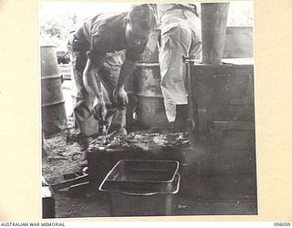 WIRUI BEACH, WEWAK AREA, NEW GUINEA. 1945-09-05. SERGEANT H. MILTON, 2/11 INFANTRY BATTALION COOKING STEAK