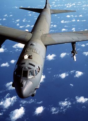 An air-to-air front view of a B-52G Stratofortress aircraft armed with an AGM-84A Harpoon missile