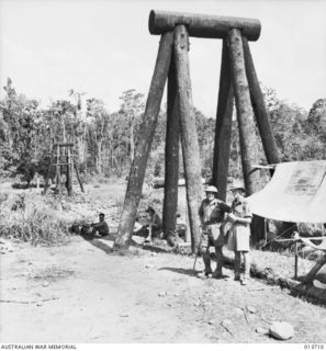 1942-12-01. NEW GUINEA. WAIROPI. ALL THAT WAS LEFT OF THE BRIDGE WERE THE PYLONS ON THE RIVER BANK. (NEGATIVE BY G. SILK)