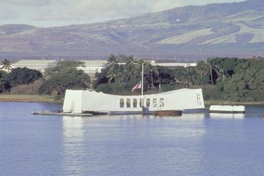 A flag flies at half-mast atop the USS ARIZONA (BB-39) Memorial to commemorate the 43rd anniversary of the Japanese attack