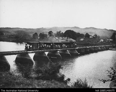 Rarawai Mill - Passenger train crossing railway bridge over Ba River