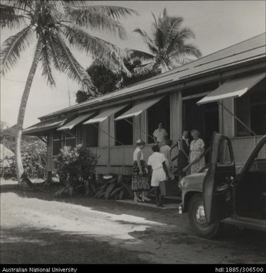 Women welcoming newcomer with suitcase