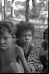 Children, one wearing a necklace