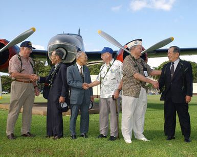 American and Japanese World War II Veterans meet in front of a B-26 Invader aircraft mock up at Hickam AFB Hawaii (HI), to commemorate the attack on Hickam Field during the Japanese invasion